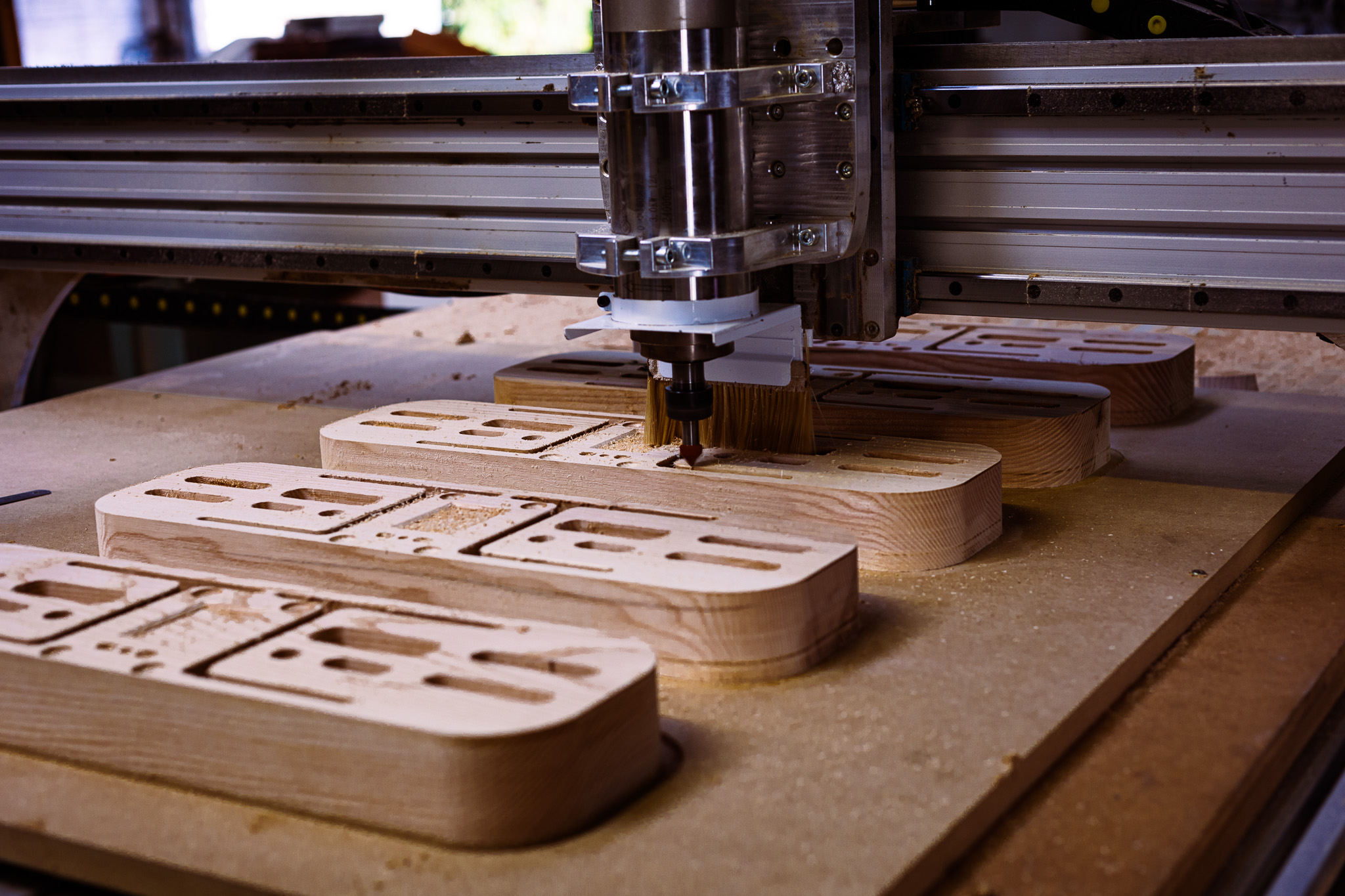 Manufacturing phase: CNC machining of a solid Ash hangboard prototype in our workshop.